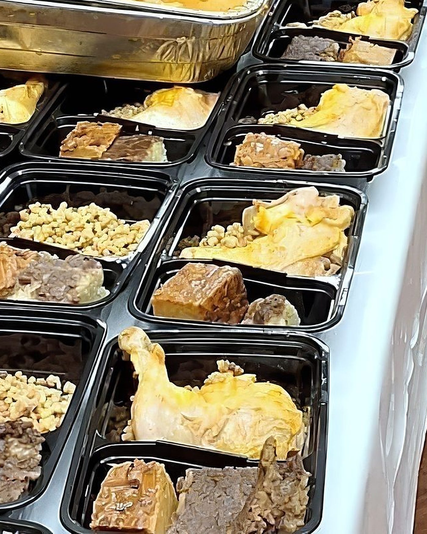 Volunteers plating meals at our Franklin Avenue prep space