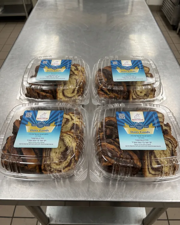 Boxed cakes, each with its meal label, ready for the Kosher rooms